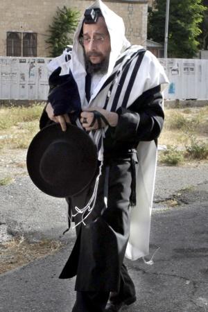 EVIL ON THE LOOSE: Avrohom Mondrowitz strolls in Jerusalem last month, scot-free after fleeing the United States in 1984 ahead of multiple child-molestation charges. Israel says hes protected from extradition.